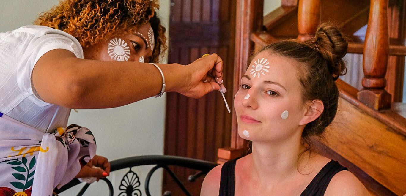 Woman getting her face painted in Madagascar