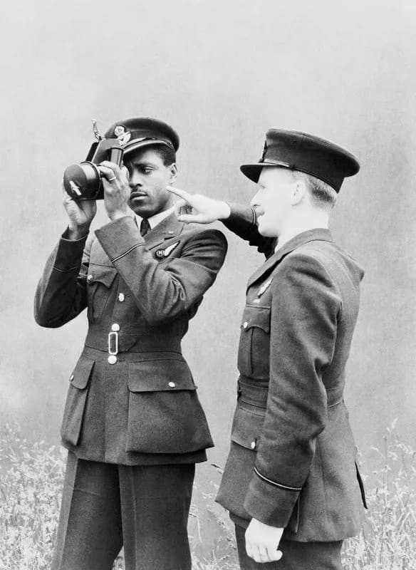 Pilot Officer J H Smythe of Sierra Leone, a newly-qualified navigator, being instructed in the use of the sextant by an instructor at No. 11