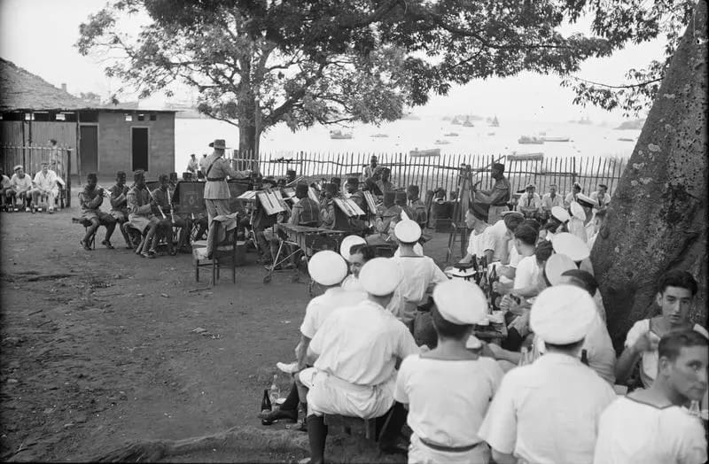 Nigerian Bandsmen Entertain British Sailors at African Port. 6 December 1942, Freetown, Sierra Leone. A13900