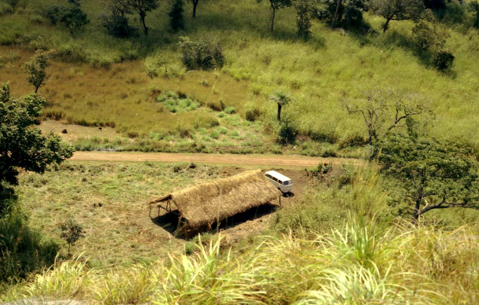 VW bus near farm shelter along road in northern Sierra Leone (West Africa) (851713453)