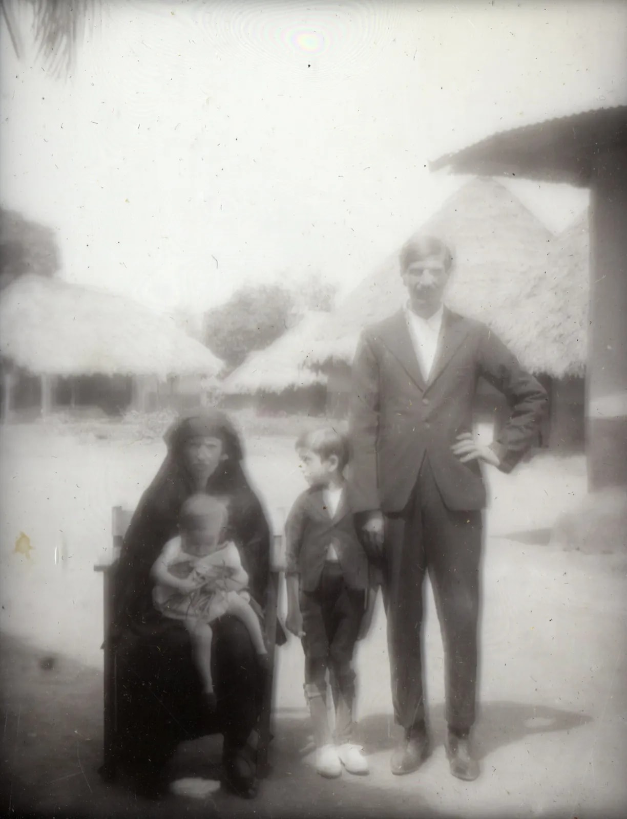 Four people in a village, Europeans among them, Panguma