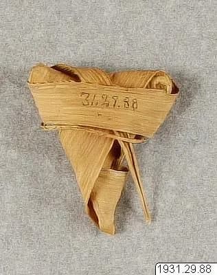 A ball of wound palm leaf, a toy