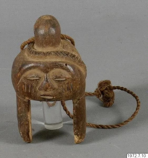 Loom pulley carved as a head with a snake