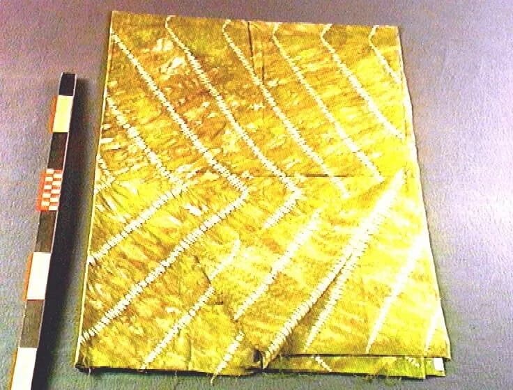 Green-brown gara cloth with white zigzags