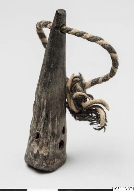 Horn amulet with five holes, worn round the neck
