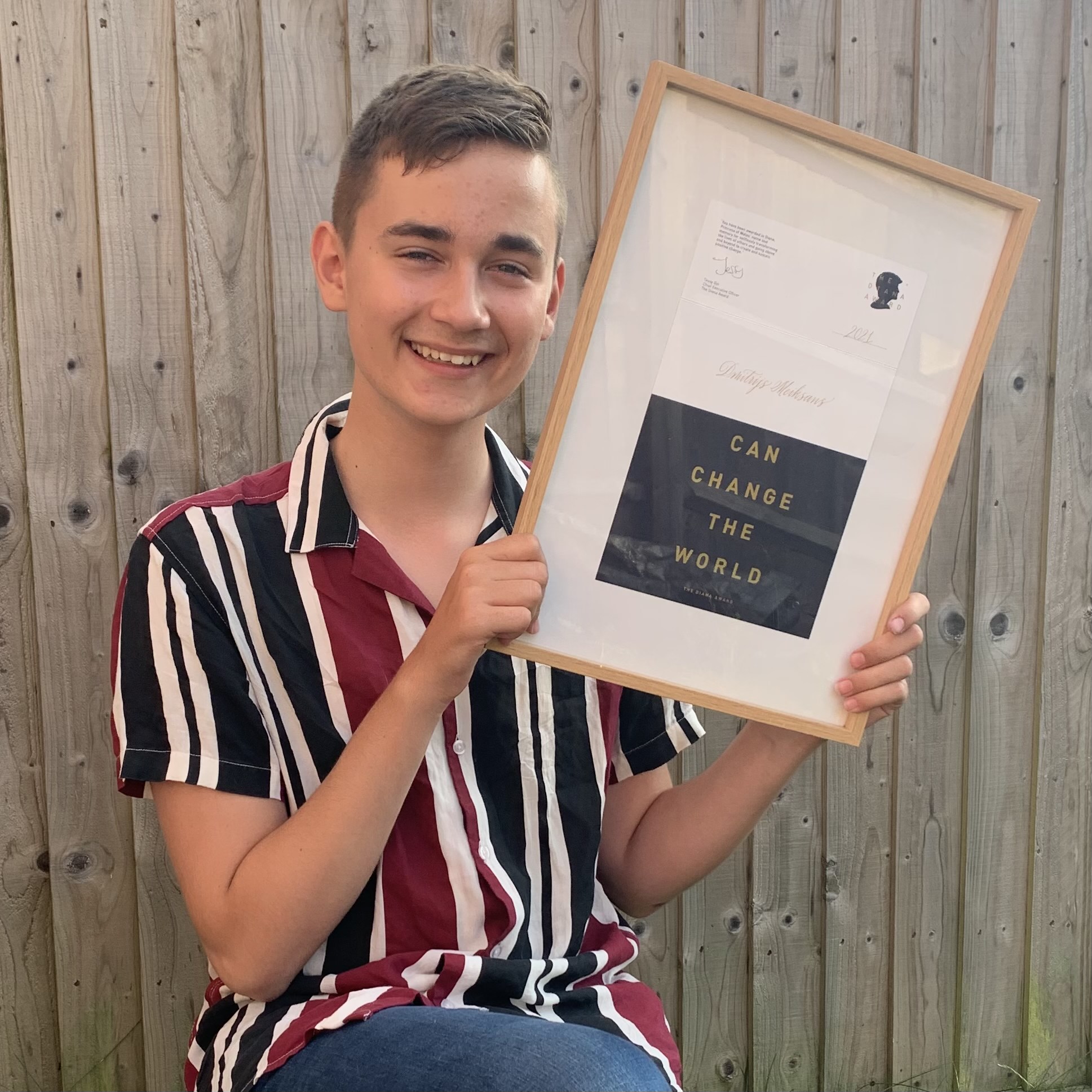 Dmitrijs holding the Diana award certificate.