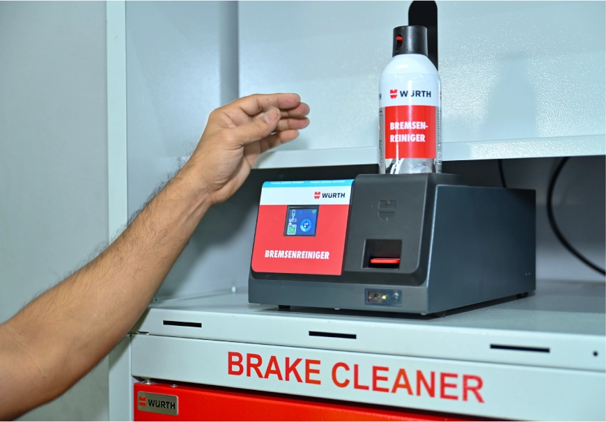 Technician placing a Brake Cleaner refill can onto the REFILLOmat station on a shelf