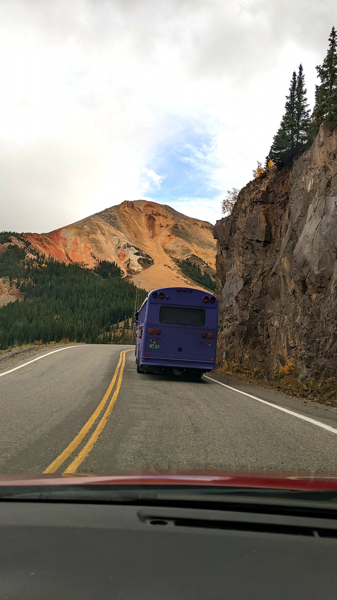 Skoolie Driving Past Red Mountain Colorado