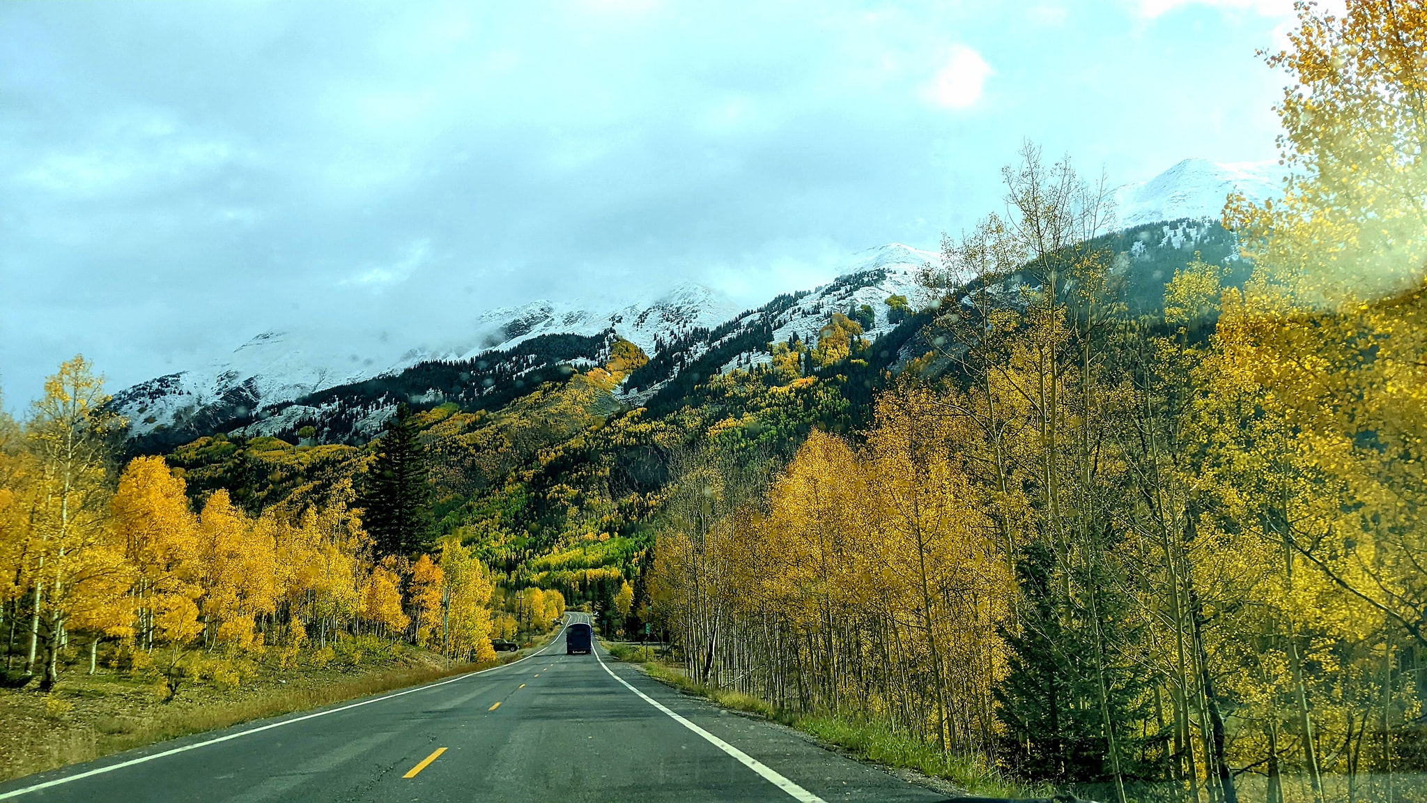 Skoolie on Mountain Road in Fall