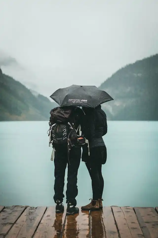 Image of rain-soaked travellers