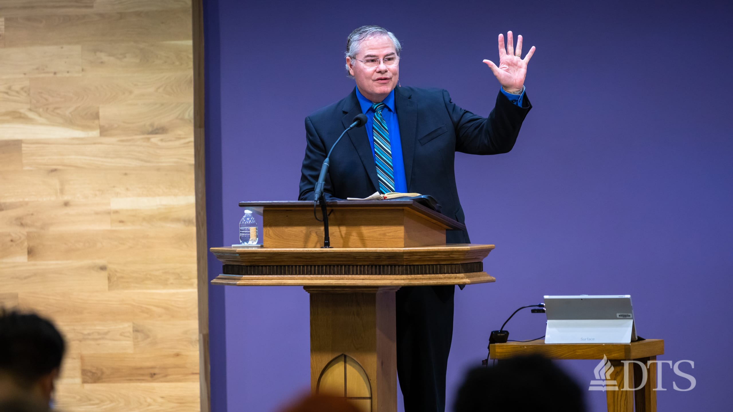 man standing at podium speaking at DTS Chapel