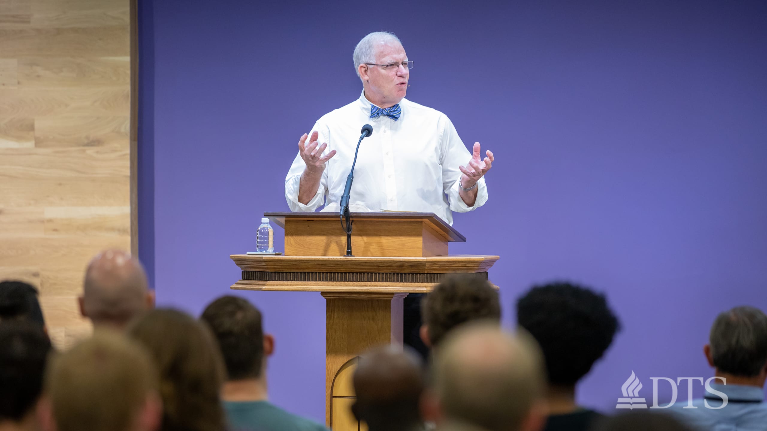 man standing at podium speaking at DTS Chapel