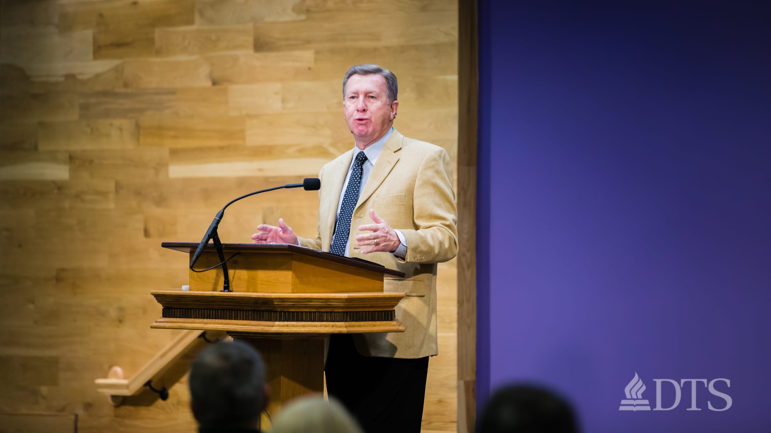 man standing at podium speaking at DTS Chapel