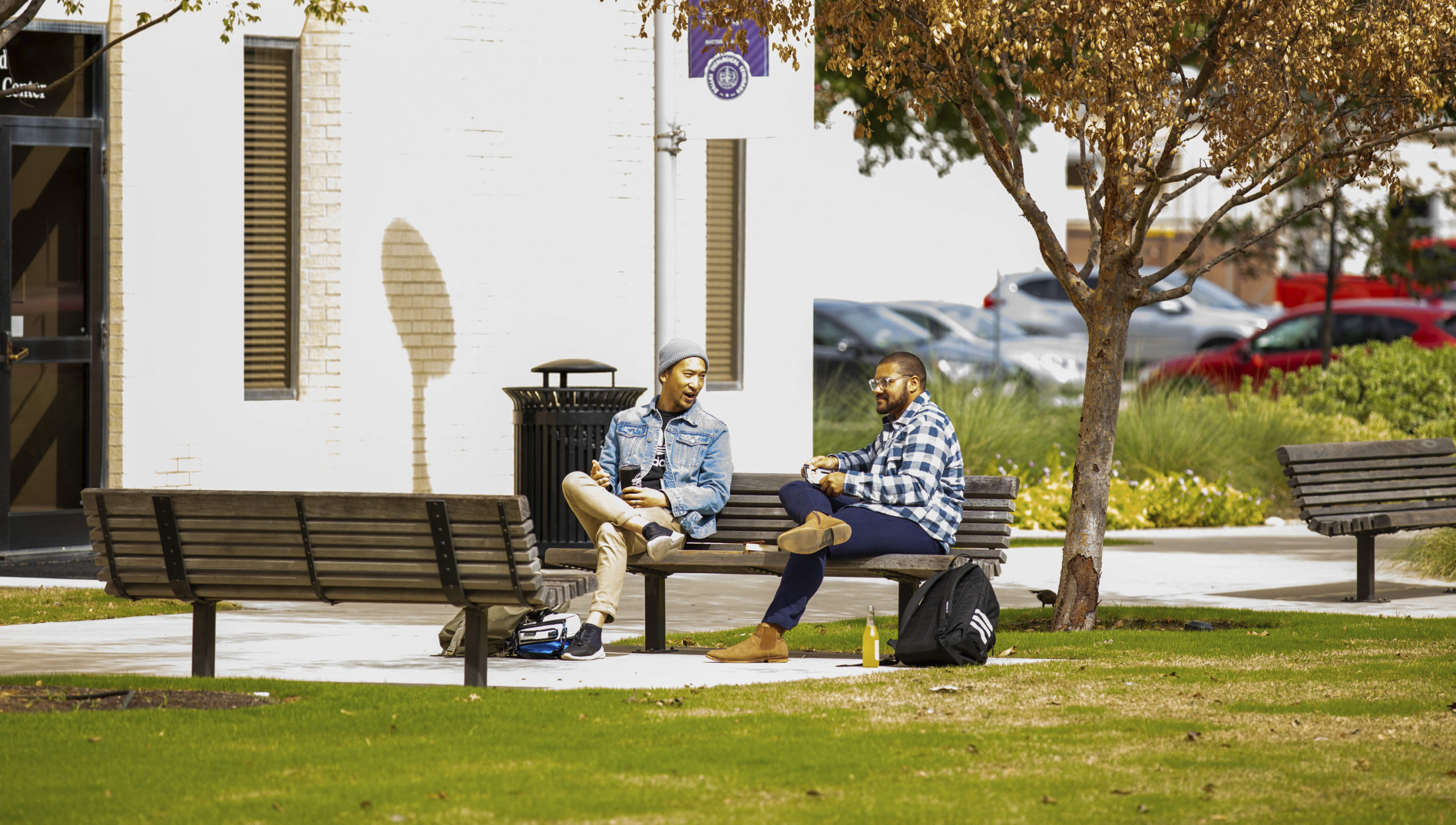 students sitting on benches in front of Todd Academic Building
