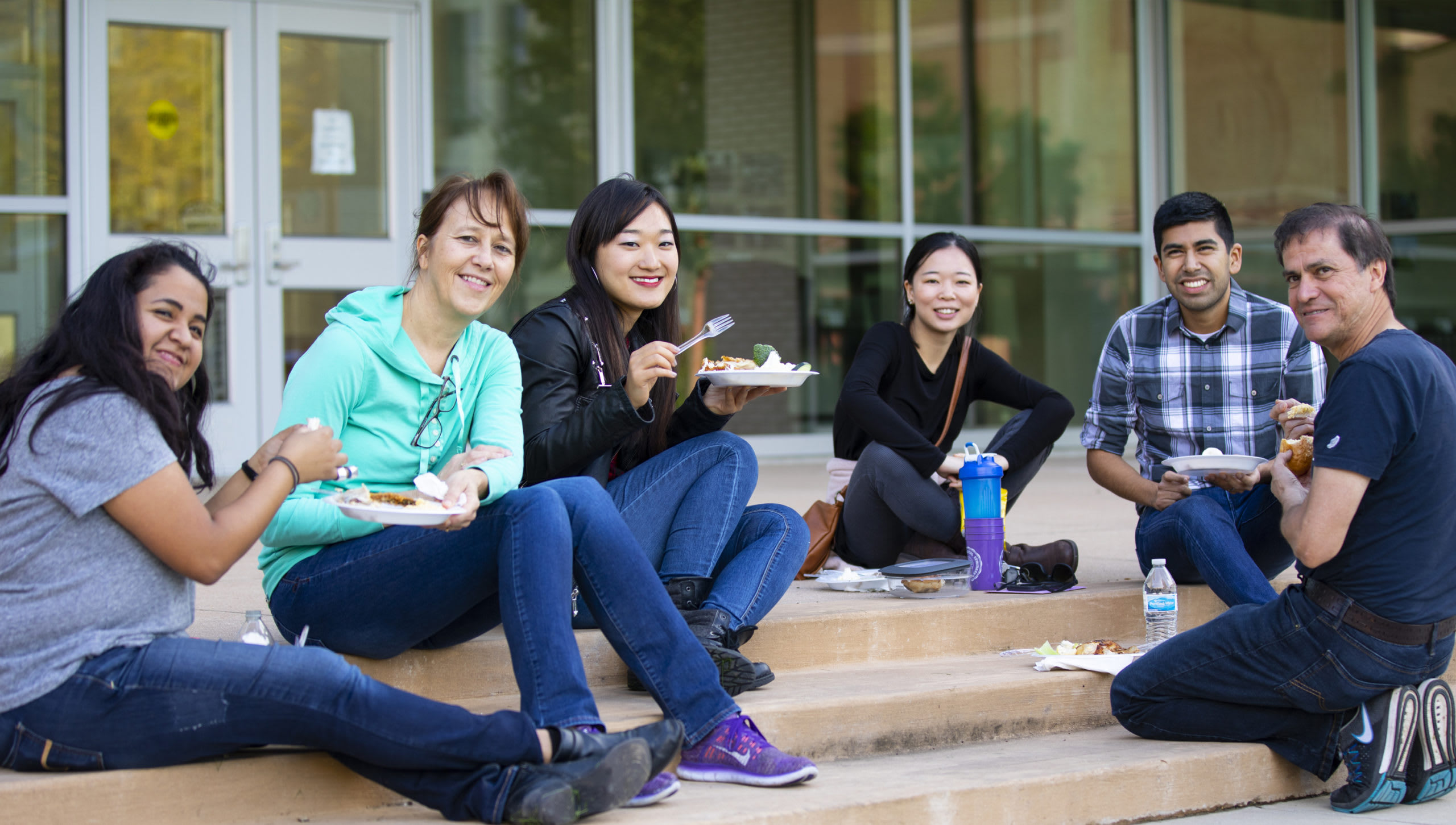 students sitting together outside