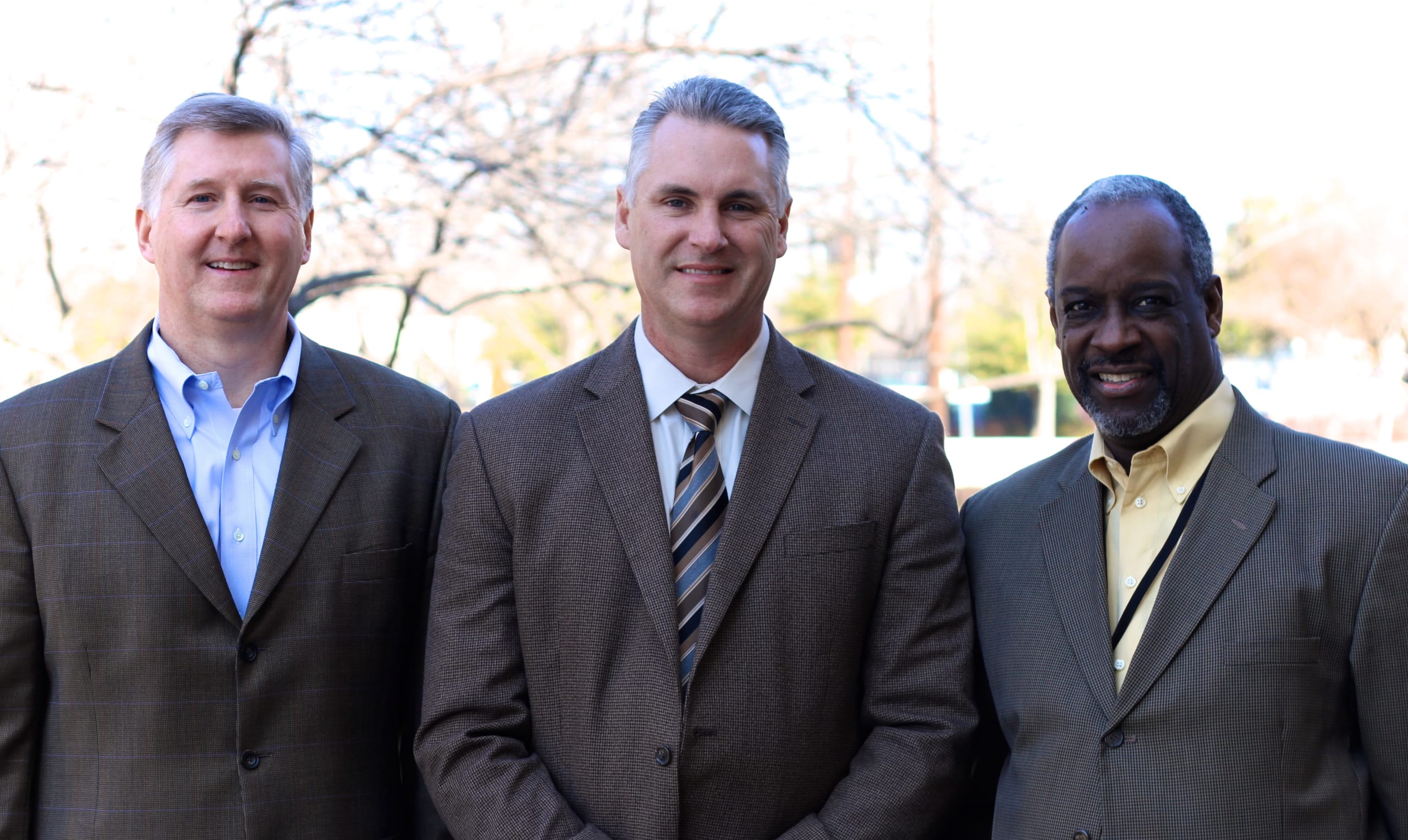 3 DTS professors standing outside on DTS campus