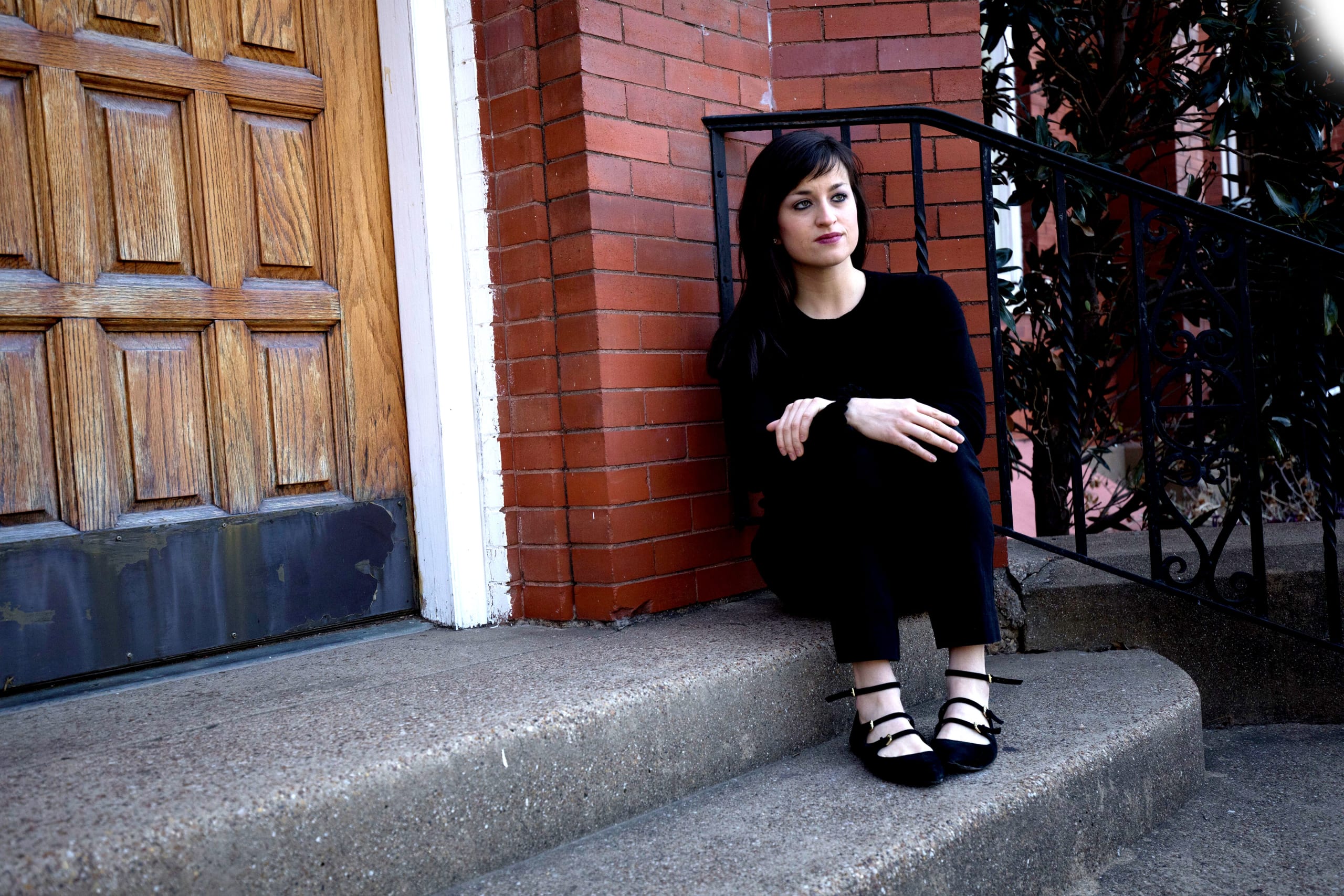 DTS alum Mary Kate Vaill sitting on steps outside door to church