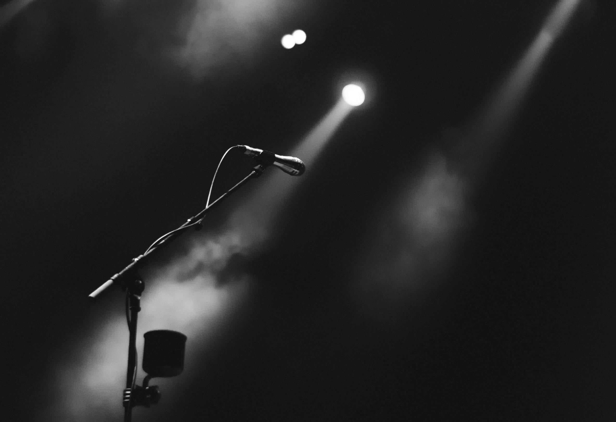 spotlighted microphone on stand