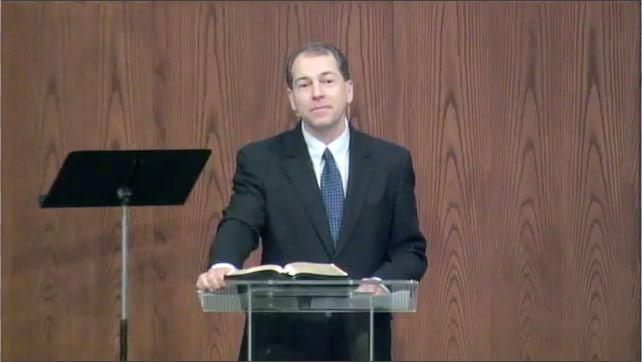 man standing at podium speaking at DTS Chapel