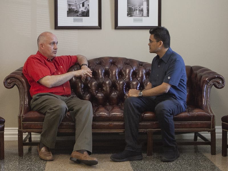 George Hillman and Mikel talking on a couch