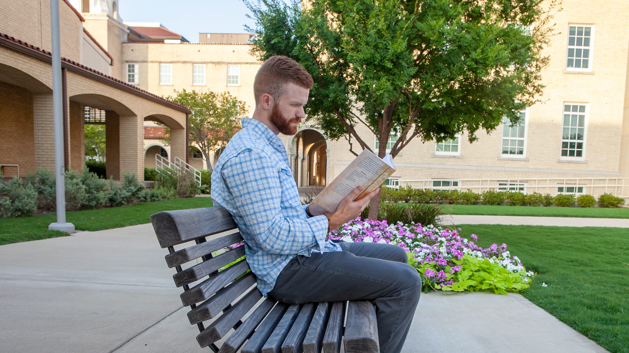 man studying in front of library