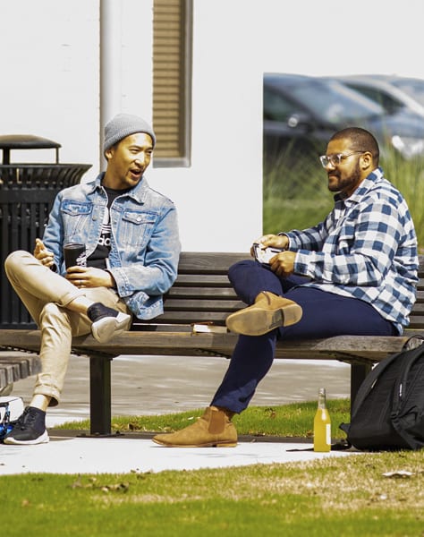 two men sitting on a bench
