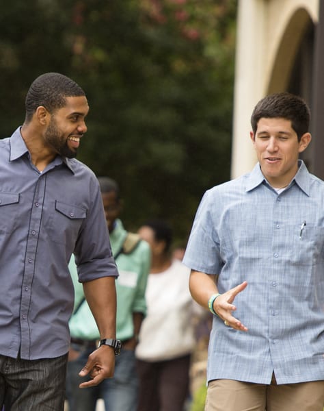 two men walking outside
