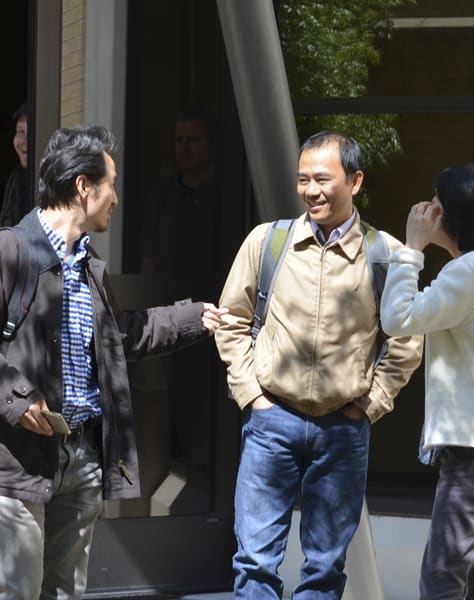 two men talking outside Washington Hall