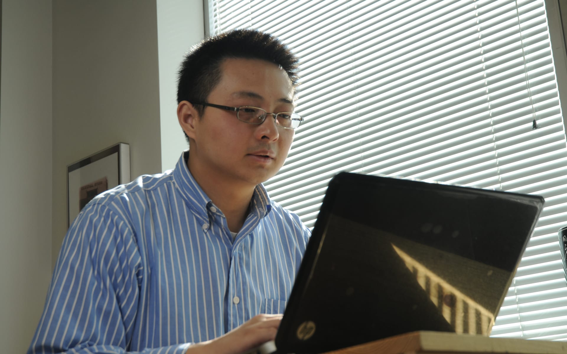 man studying on his laptop