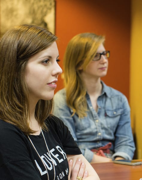 two women sitting in class
