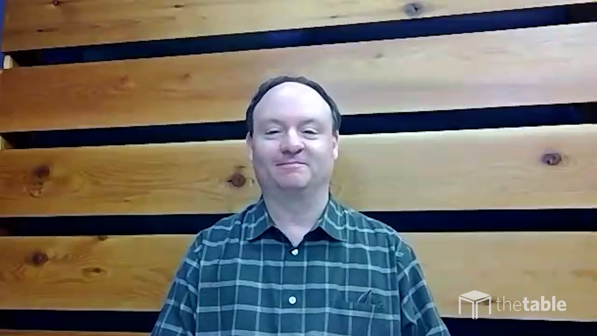 A screenshot of Dr. Joseph Fantin in front of a slatted wall
