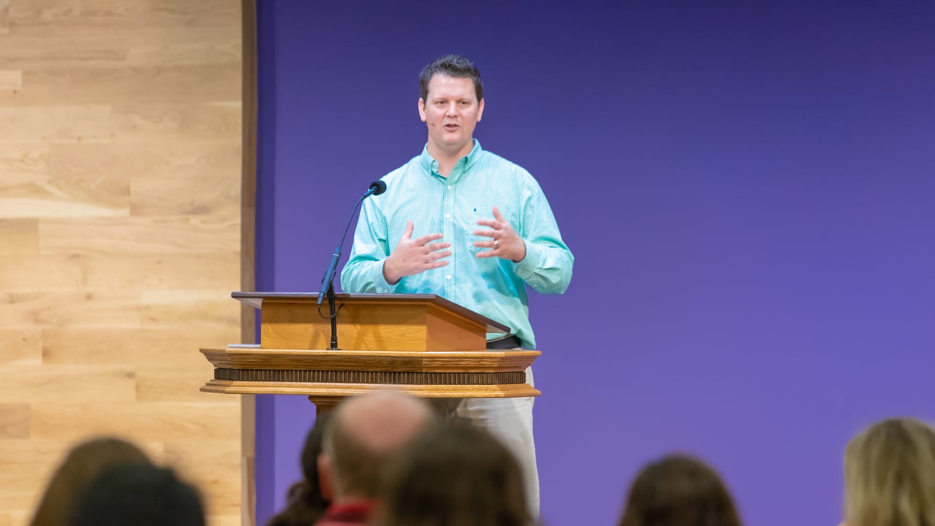 man standing at podium speaking at DTS Chapel