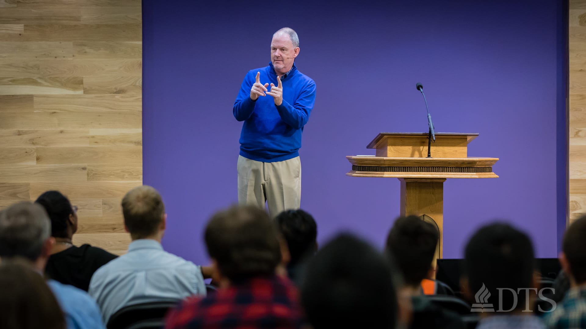 man standing near podium speaking at DTS Chapel