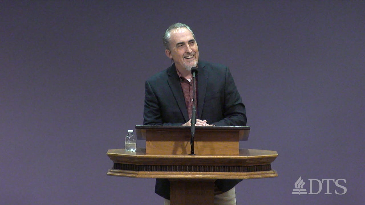 Dr. Mark Yarbrough standing at a podium speaking at DTS Chapel