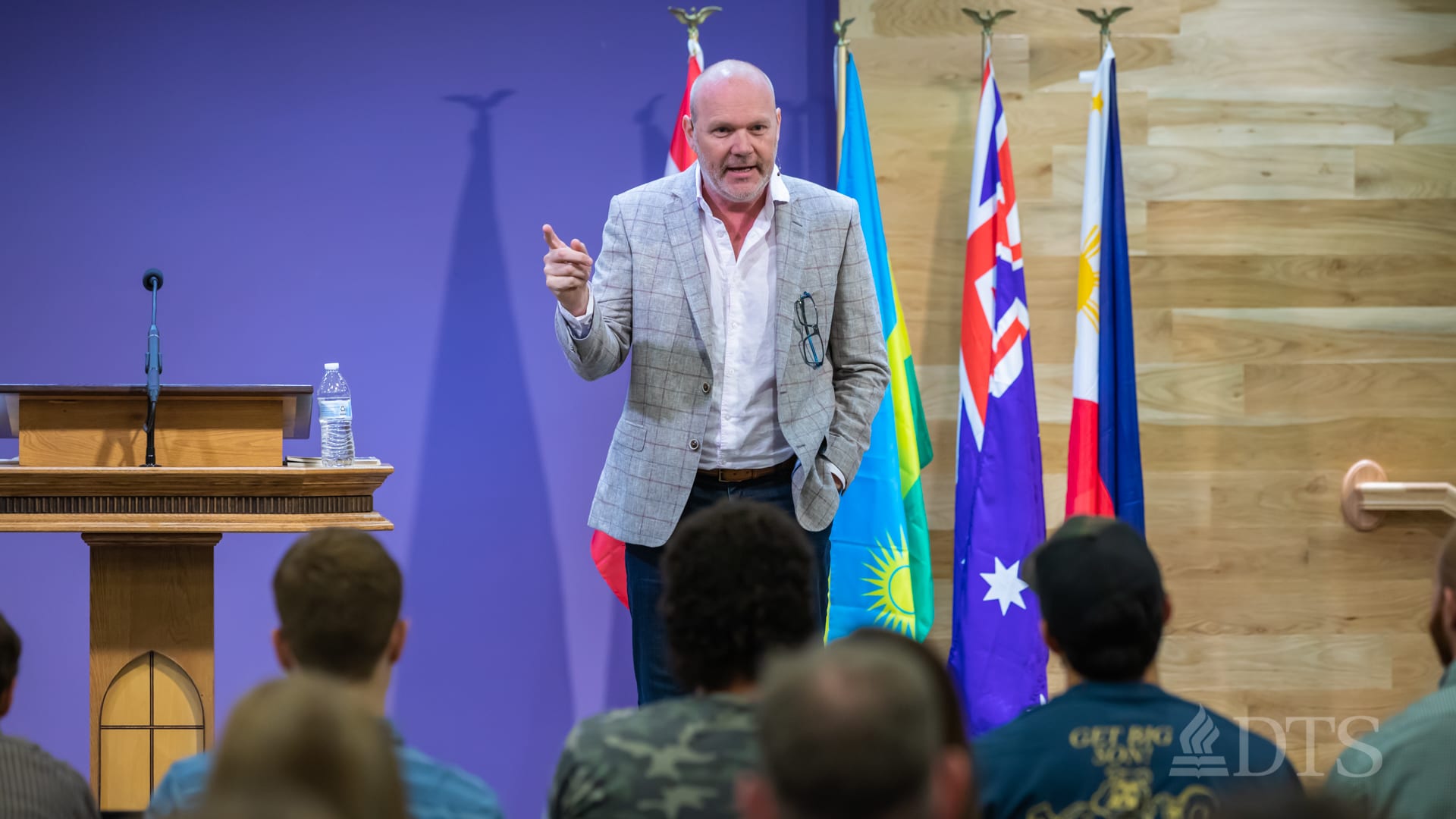 man standing at podium speaking at DTS Chapel