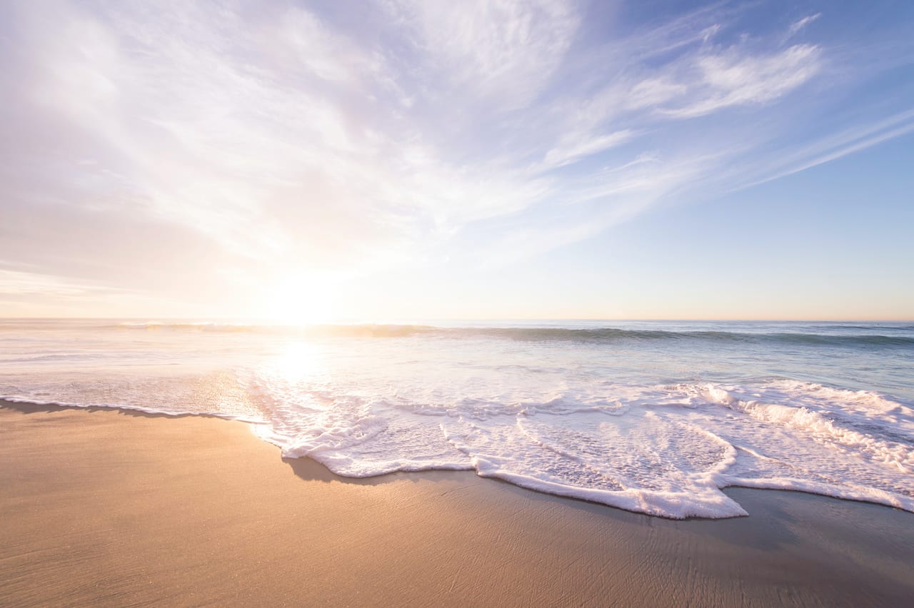 Sandy beach with gentle surf on a sunny day