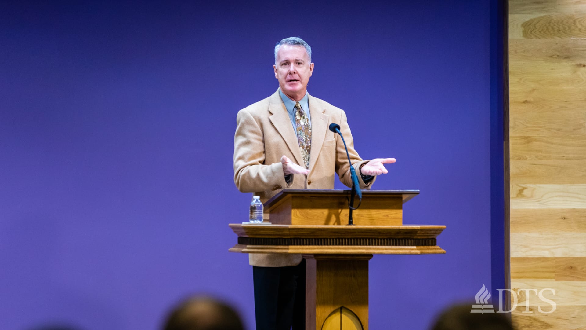 man standing at podium speaking at DTS Chapel