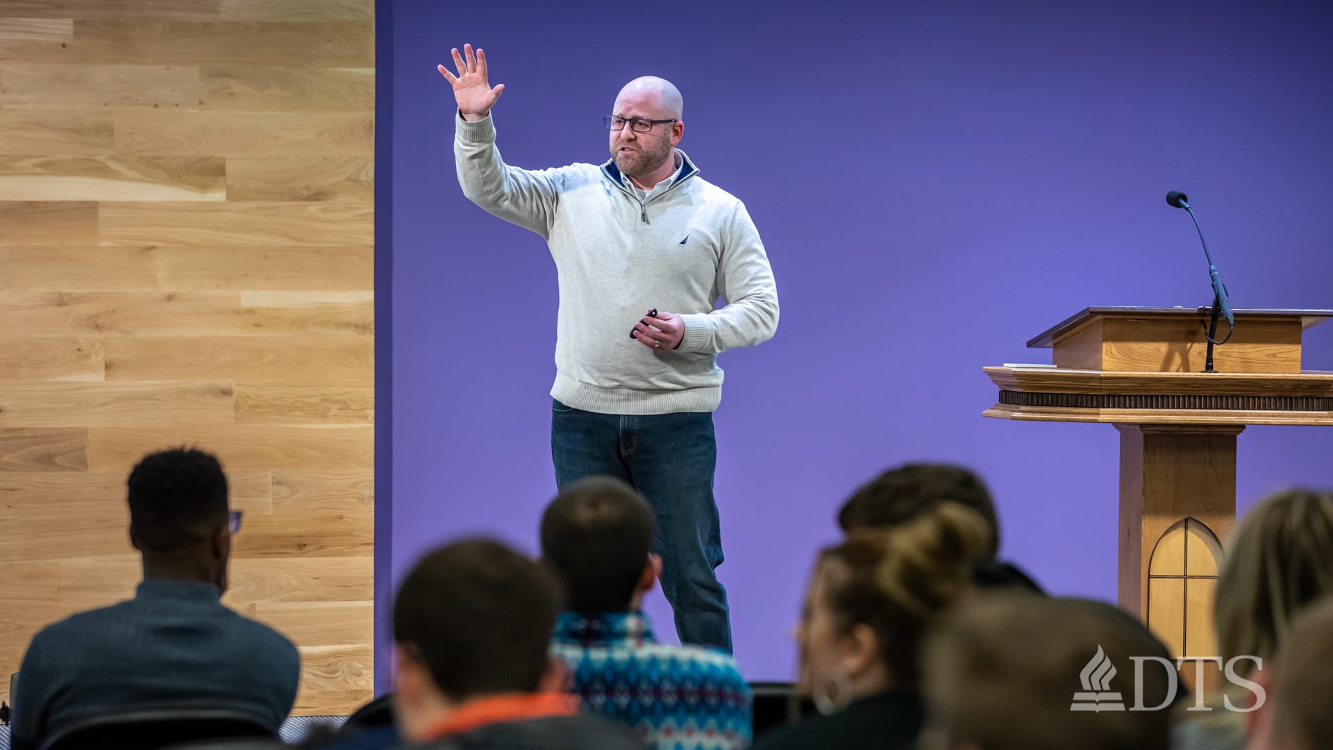man standing next to podium speaking at DTS Chapel