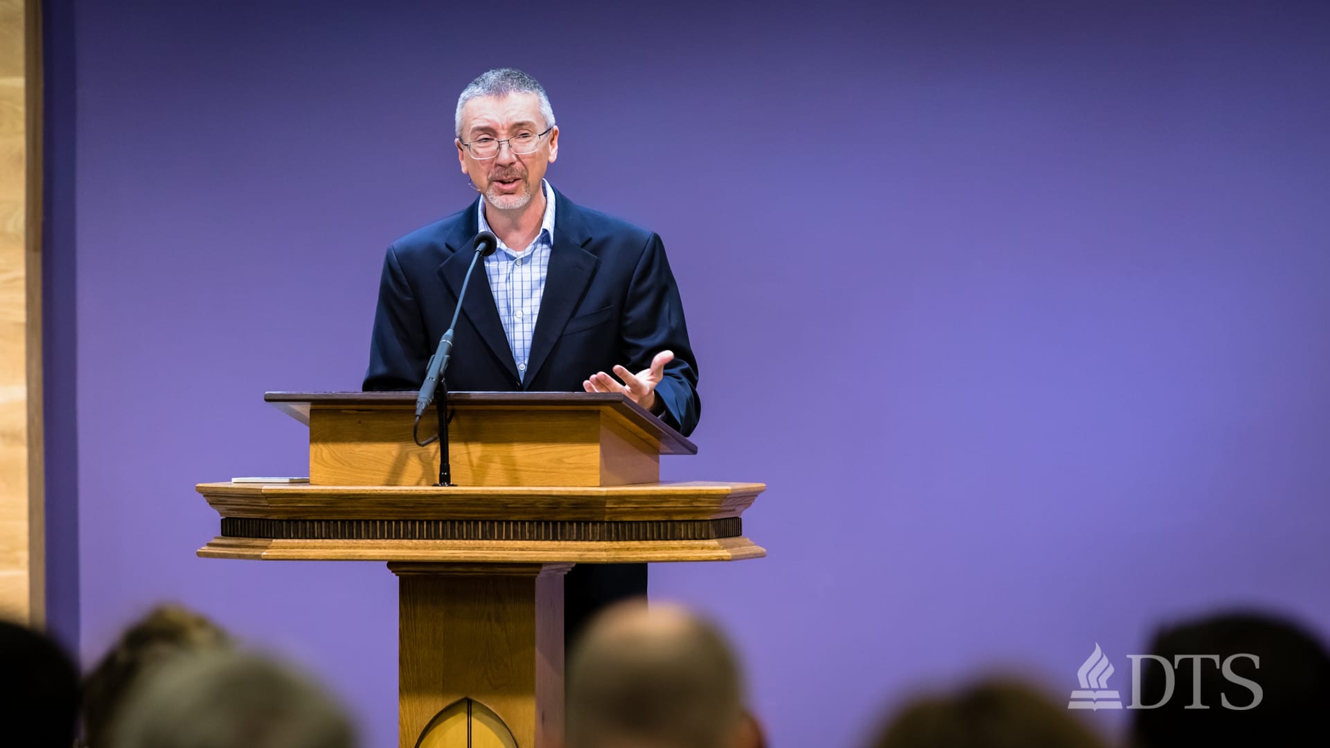 Scott Stonehouse standing at the podium speaking at DTS Chapel