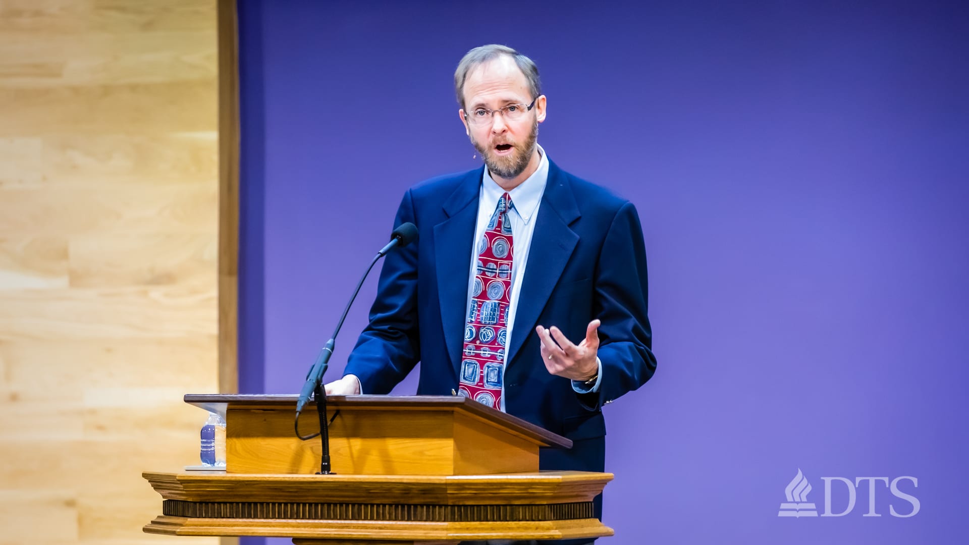man standing at podium speaking at DTS Chapel