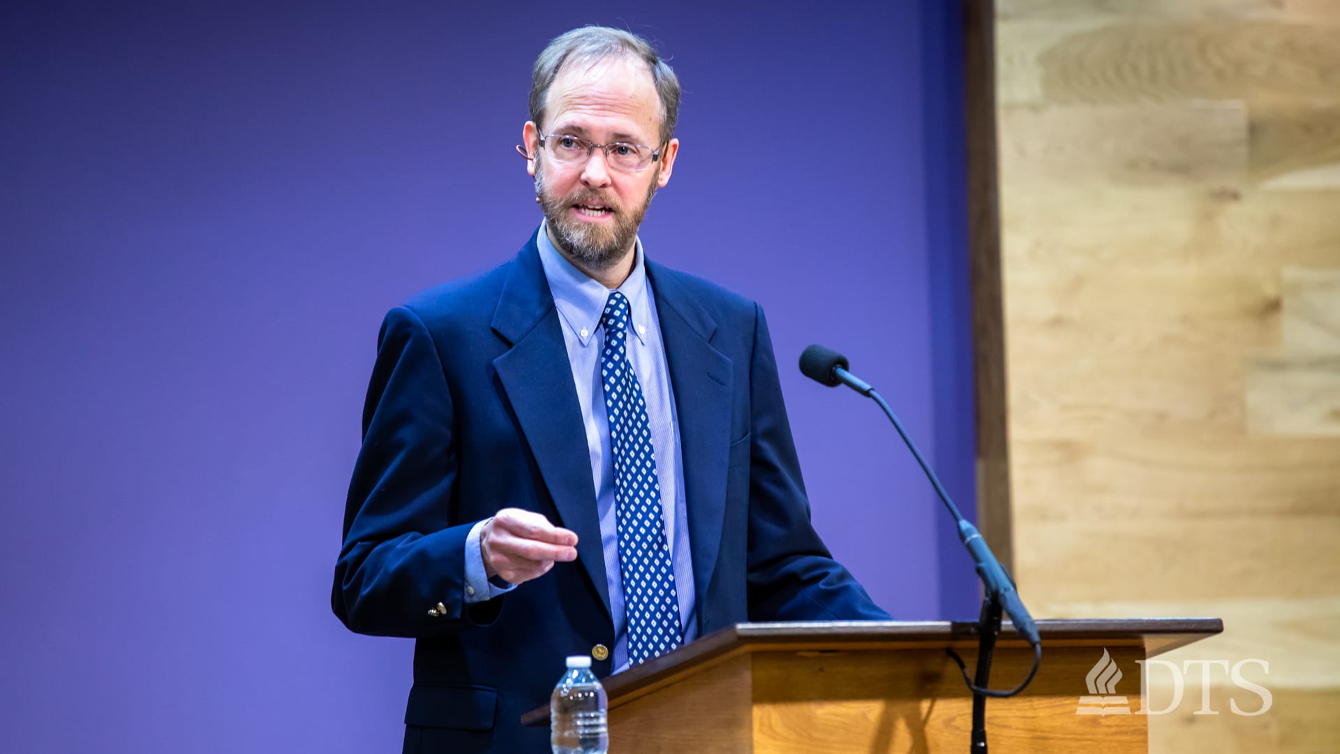 man standing at podium speaking at DTS Chapel