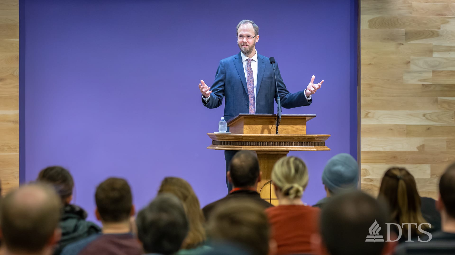 man standing at podium speaking at DTS Chapel