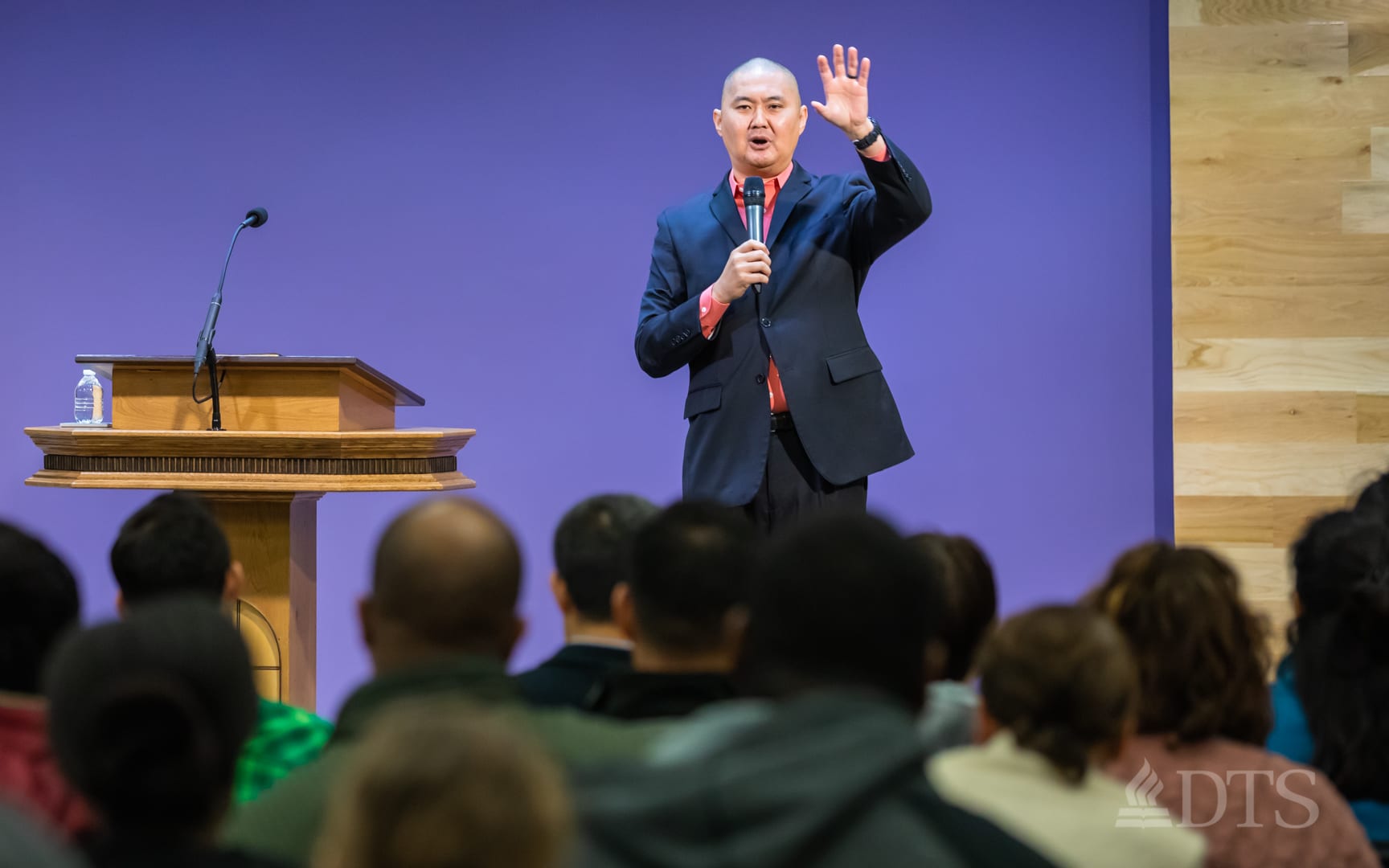 man standing at podium speaking at DTS Chapel