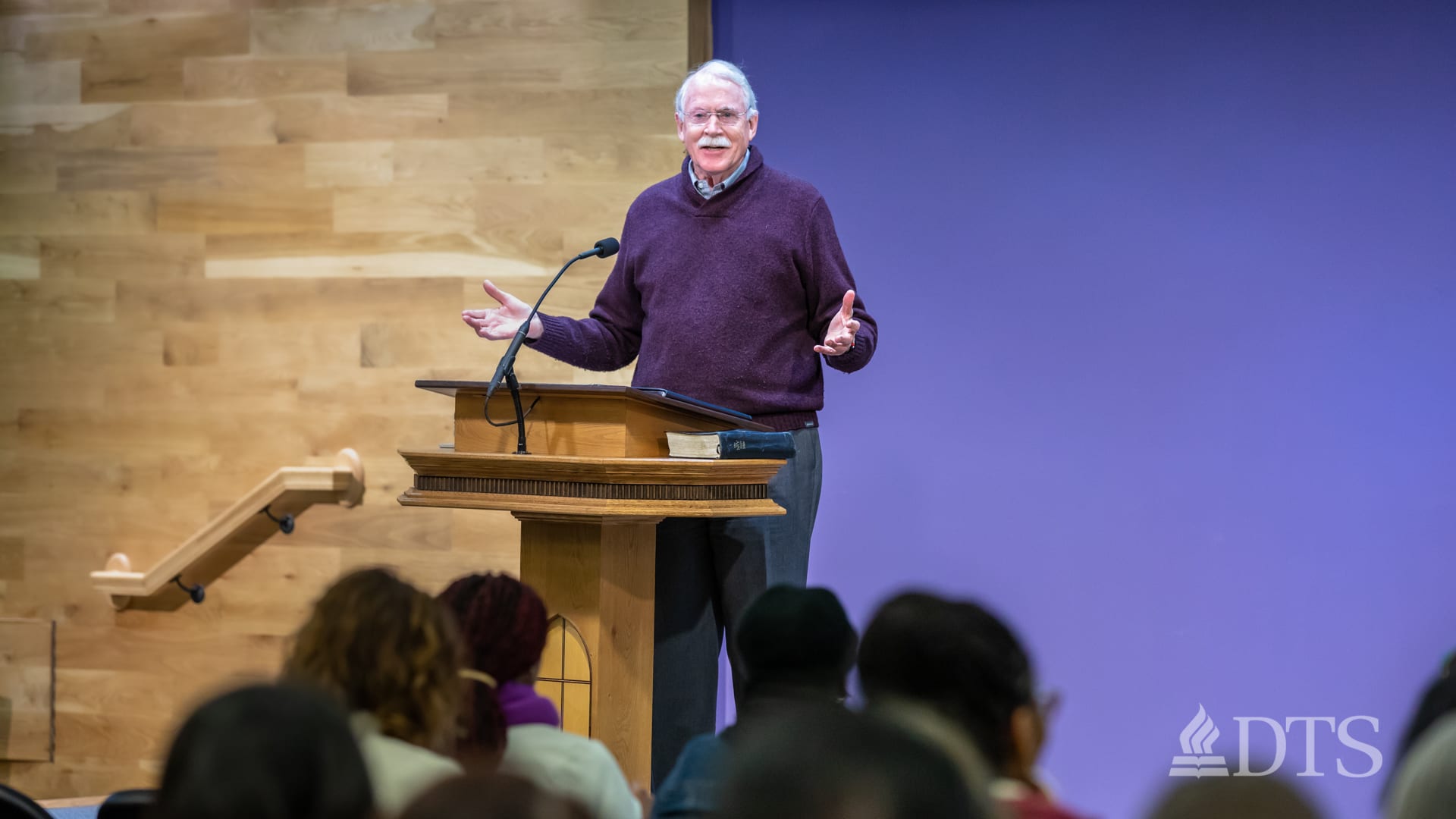 man standing at podium speaking at DTS Chapel