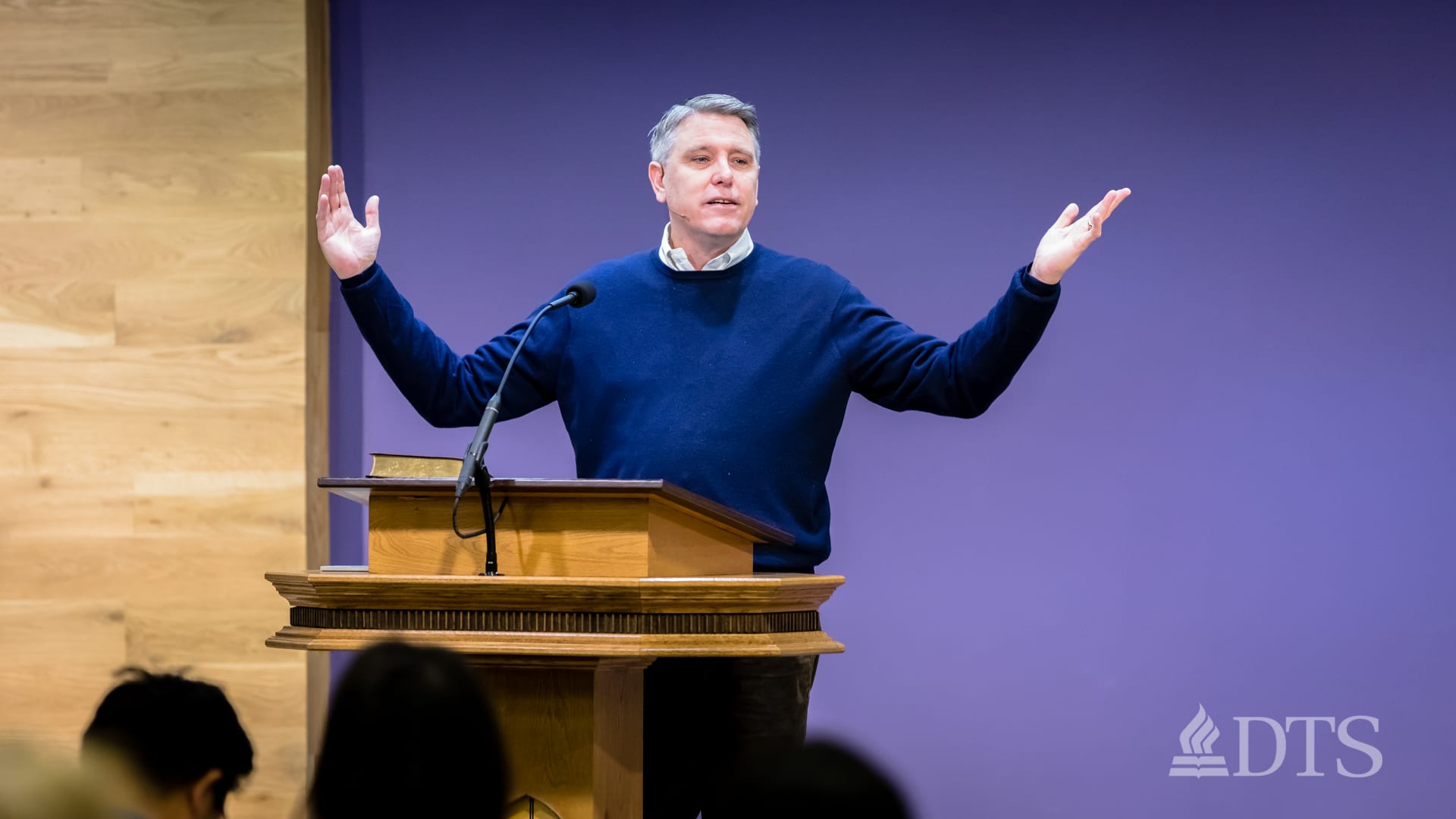 man standing at podium speaking at DTS Chapel