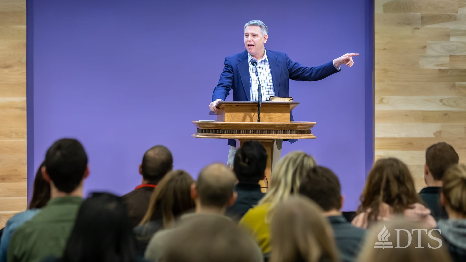man standing at podium speaking at DTS Chapel