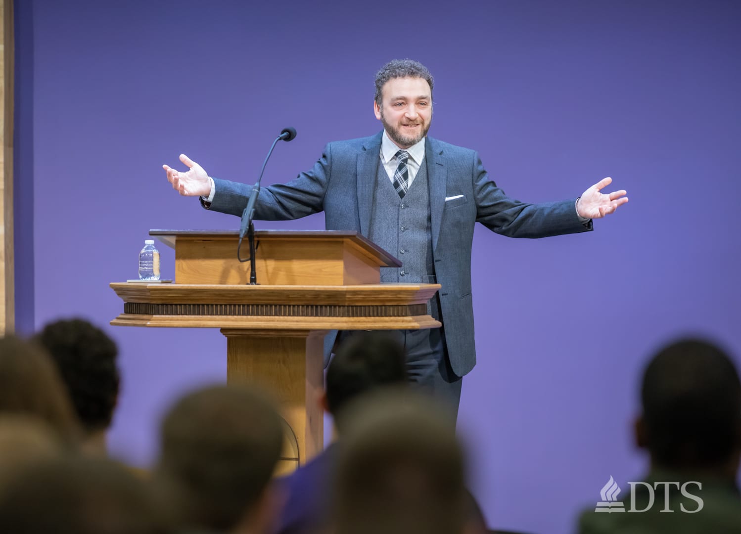 man standing at podium speaking at DTS Chapel
