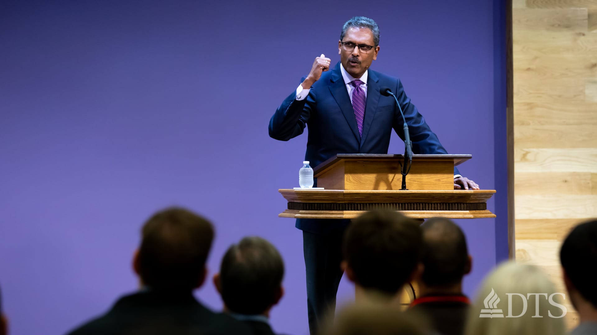 man standing at podium speaking at DTS Chapel