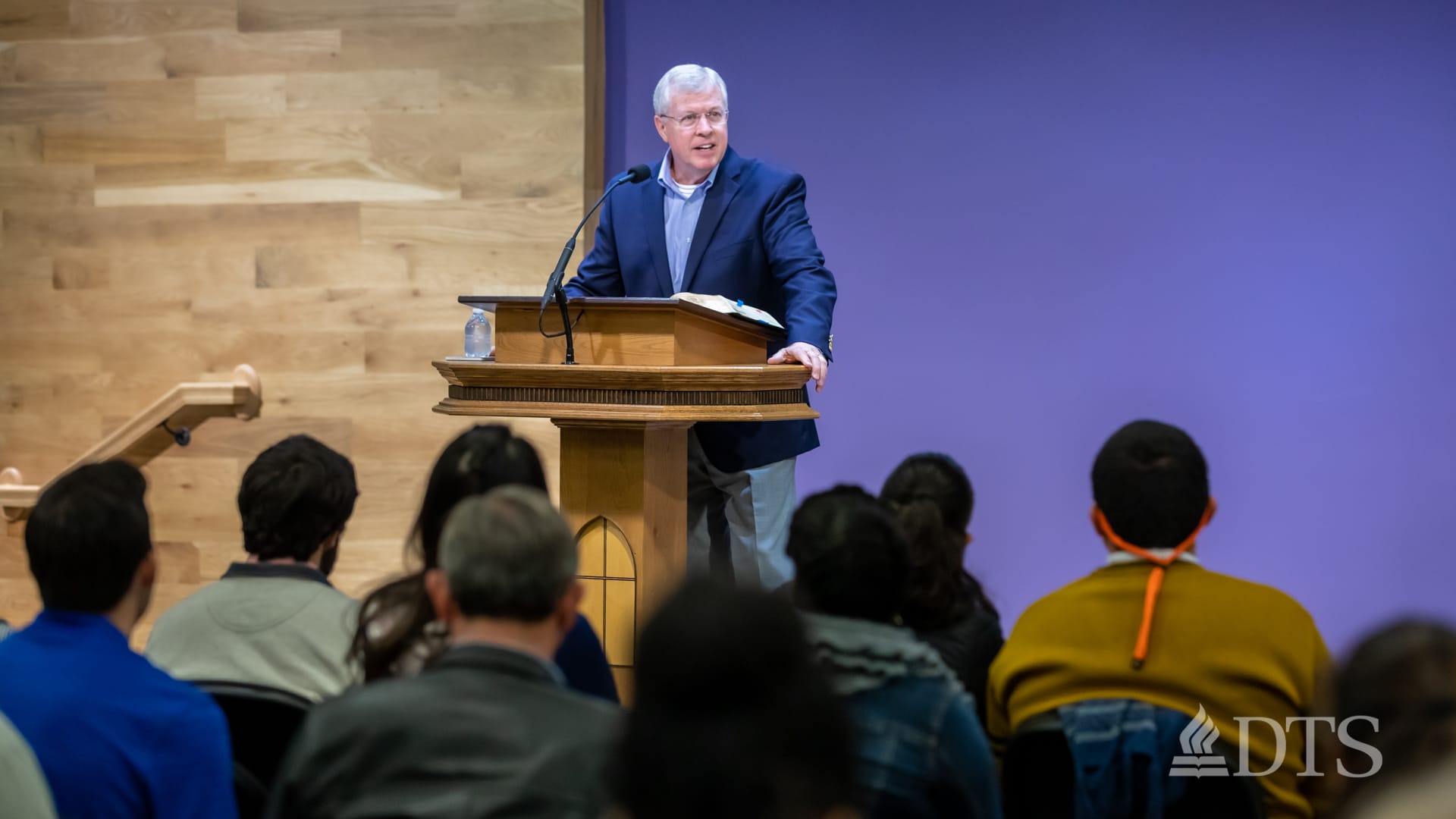 man standing at podium speaking at DTS Chapel