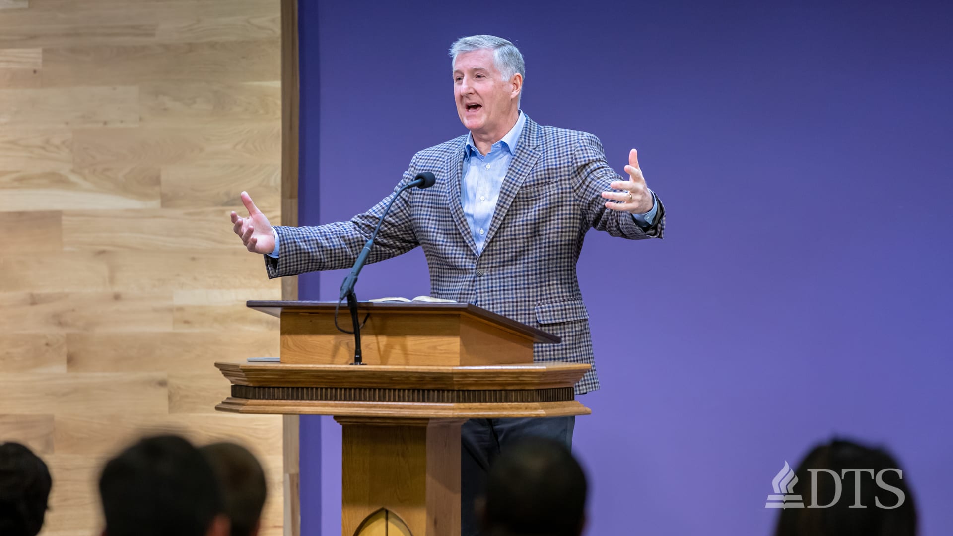 man standing at podium speaking at DTS Chapel